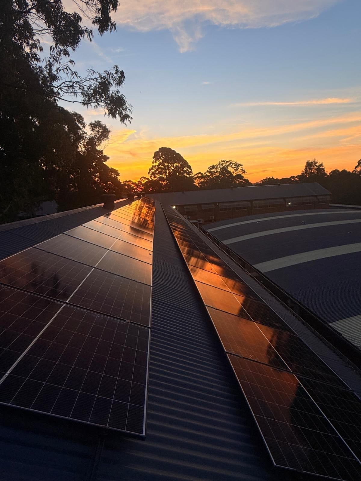 MF Energy solar array on a roof at sunset