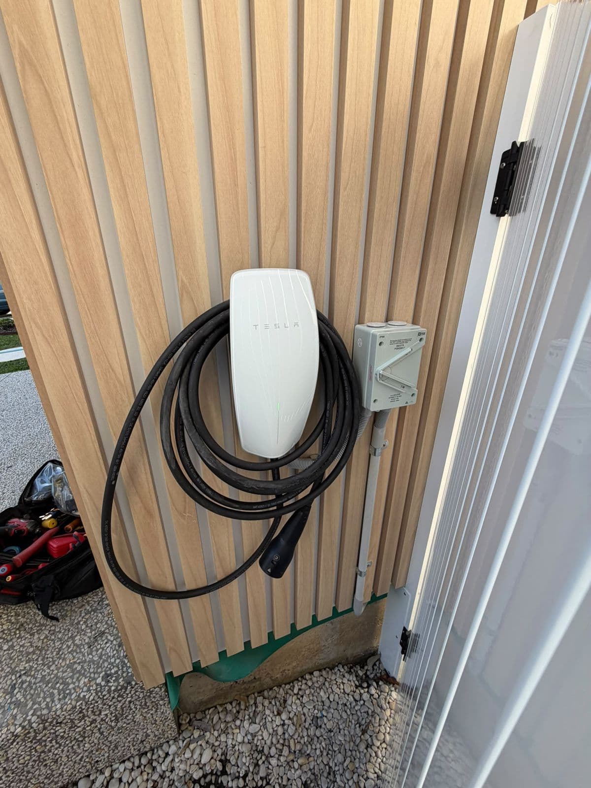 Tesla Wall Connector installed by MF Energy on a timber-clad wall in Wollongong